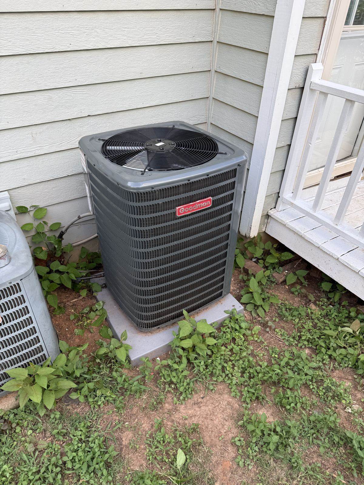 Condenser unit serviced on exterior pad